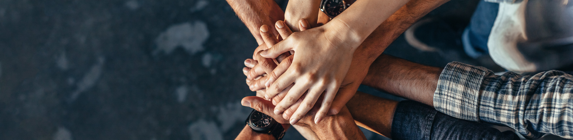 Hands on top of each other in a huddle